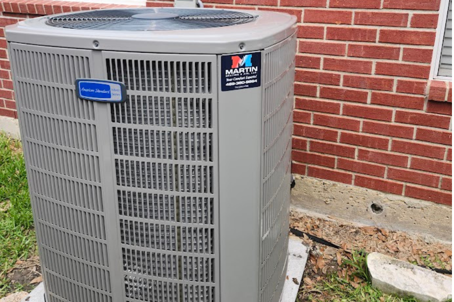 image of an HVAC outside unit with a Martin Heating and Air sticker